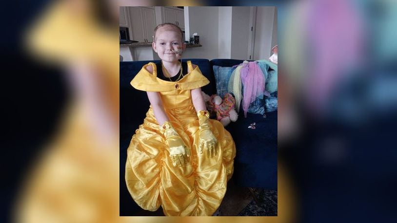 Naomi Short, 9, of Hamilton, wears a Belle costume during her visit to Disney properties in Orlando. Short has been diagnosed with a rare form of brain cancer and her family has traveled around the United States. SUBMITTED PHOTO
