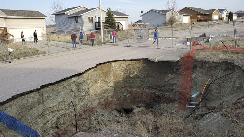 This photo taken April 27, 2022, by Tonya Junker shows a sinkhole in the Hideaway Hills neighborhood near Rapid City, S.D. (Tonya Junker via AP)