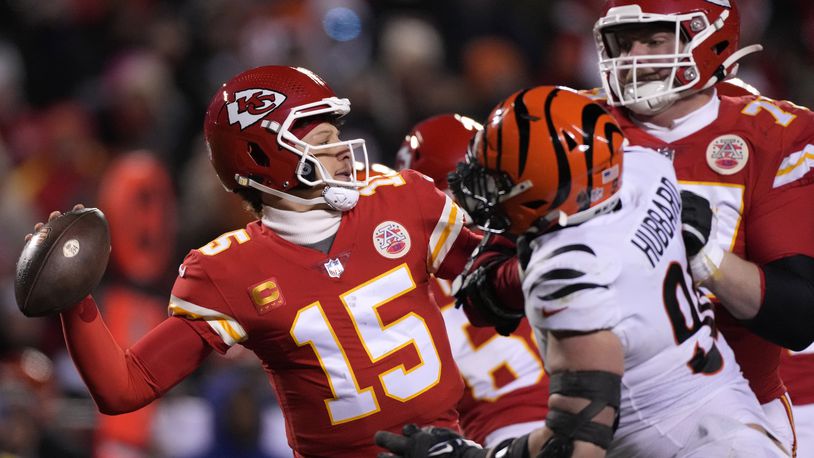 Kansas City Chiefs quarterback Patrick Mahomes (15) passes under pressure from the Cincinnati Bengals during the second half of the NFL AFC Championship playoff football game, Sunday, Jan. 29, 2023, in Kansas City, Mo. (AP Photo/Jeff Roberson)