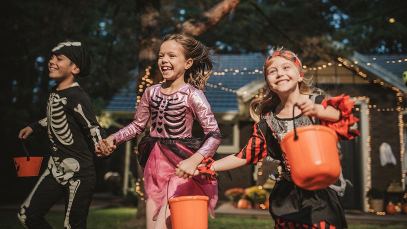 Check out the hours for trick-or-treat in your area. Pictured are kids trick or treating during Halloween. SVETIKD/ISTOCK