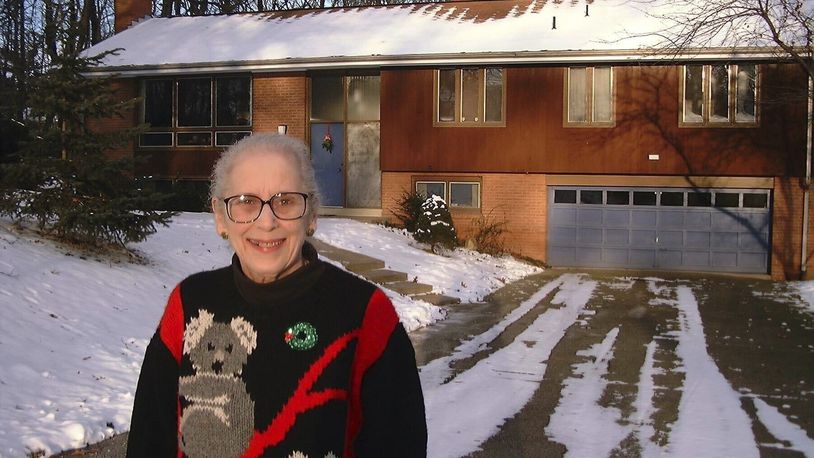 FILE - Ann T. Anthony poses for a photo on Dec, 26, 1998 in front of her home in Allison Park, Pa. (AP Photo/Ted Anthony, File)