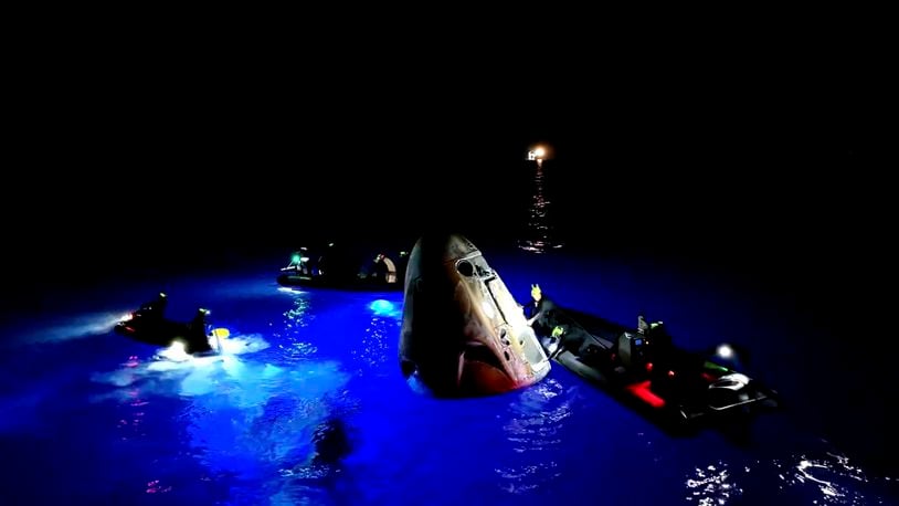 This image made from SpaceX video shows its capsule, center, carrying tech entrepreneur Jared Isaacman with his crew after it reached the Gulf of Mexico near Florida's Dry Tortugas early Sunday, Sept. 15, 2024. (SpaceX via AP)