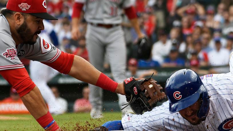 CHICAGO, ILLINOIS - MAY 25: Eugenio Suarez #7 of the Cincinnati Reds tags out Kris Bryant #17 of the Chicago Cubs at third base during the first inning at Wrigley Field on May 25, 2019 in Chicago, Illinois. (Photo by David Banks/Getty Images)