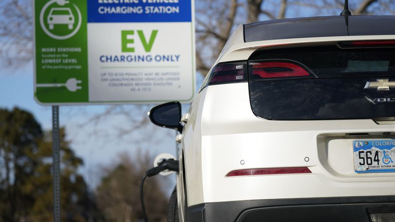 FILE - A Chevrolet Volt charges at at a station outside the Denver Museum of Nature and Science Tuesday, Jan. 5, 2020, in east Denver. (AP Photo/David Zalubowski, File)