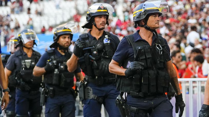 FILE - Police are seen near the pitch during a men's semifinal soccer match between Morocco and Spain at the 2024 Summer Olympics, Monday, Aug. 5, 2024, at Marseille Stadium in Marseille, France. Spain won 2-1. (AP Photo/Julio Cortez, File)