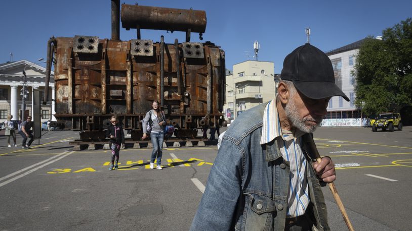 A man passes by a burnt transformer from one of power plants badly damaged in one of Russia's recent missile attacks on energy system in Kyiv, Ukraine, Thursday, Sept. 19, 2024. (AP Photo/Efrem Lukatsky)