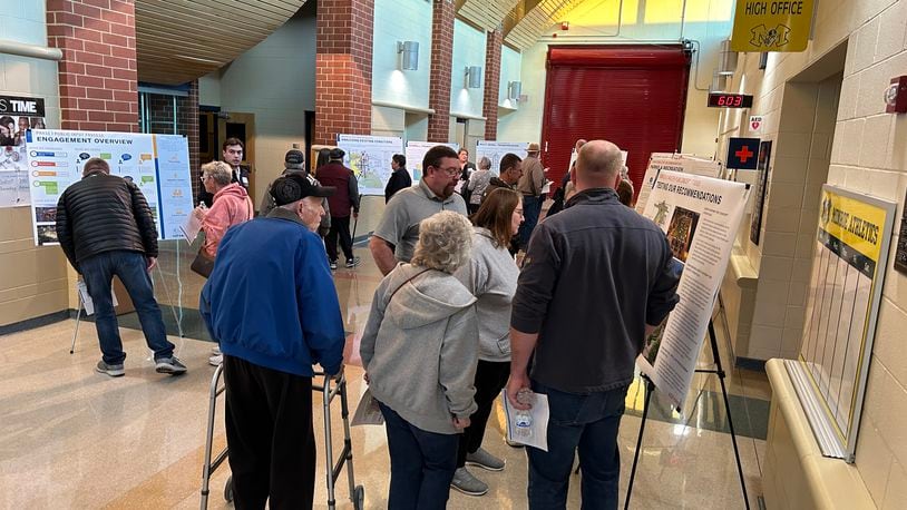 About 50 Monroe residents attended a Downtown Master Plan meeting Monday night at the high school. Several drawings of potential designs for the downtown area were displayed in the school lobby. RICK McCRABB/STAFF