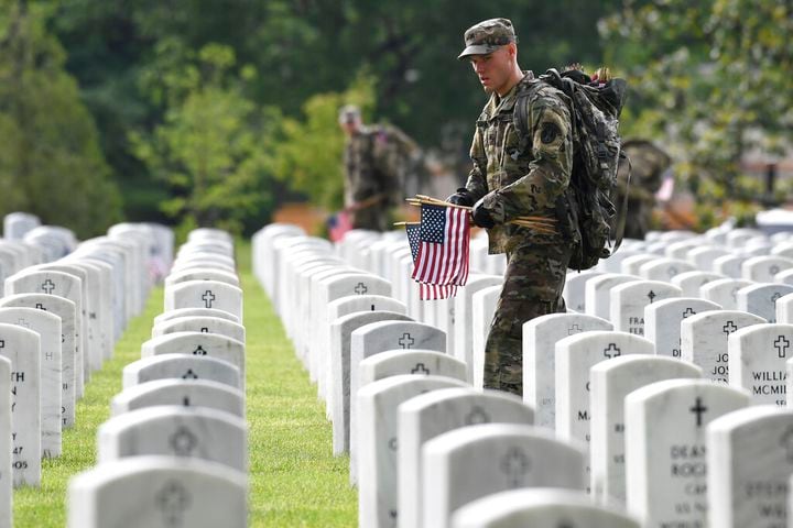 Soldiers place flags at Arlington National Cemetery for Memorial Day