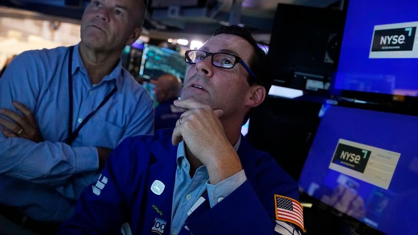 FILE - Specialist John McNierney, right, works with a colleague on the floor of the New York Stock Exchange, Aug. 7, 2024. (AP Photo/Richard Drew, File)