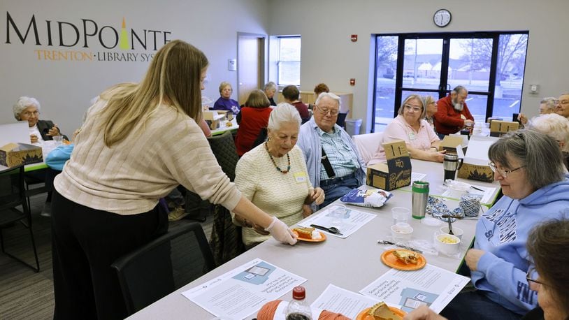 A group of seniors gathered last year for lunch and fellowship at the MidPointe Library in Trenton. The weekly event for those 60 and older provides free lunch, activities and time to connect with other seniors. NICK GRAHAM/STAFF