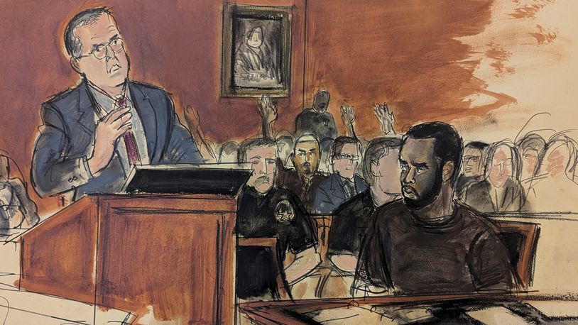 In this courtroom sketch, Sean Combs, seated right, looks at his attorney, Marc Agnifilo, left, as he delivers his bail argument as Combs' family in the gallery, background, raise their hands indicating to Judge Tarnofsky that they are in attendance, to bolster the defense attorney's bail argument, Tuesday, Sept. 17, 2024, in Manhattan Federal Court in New York. (Elizabeth Williams via AP)