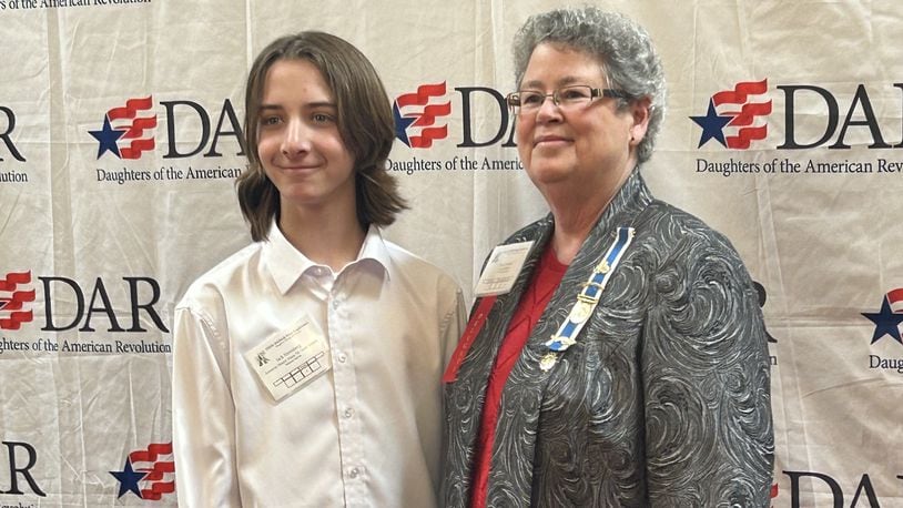 Monroe Schools’ 7th grader Jack Nerenberg’s essay just won national first place in the Daughters of the American Revolution (DAR) contest. Nerenberg received $2,500 from the organization and will travel to Washington, D.C. to the group’s national convention this summer to read a portion of his award-winning essay. He is pictured receiving his initial state award in Columbus with DAR representative Nancy Hutton. CONTRIBUTED