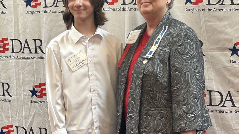 Monroe Schools’ 7th grader Jack Nerenberg’s essay just won national first place in the Daughters of the American Revolution (DAR) contest. Nerenberg received $2,500 from the organization and will travel to Washington, D.C. to the group’s national convention this summer to read a portion of his award-winning essay. He is pictured receiving his initial state award in Columbus with DAR representative Nancy Hutton. CONTRIBUTED