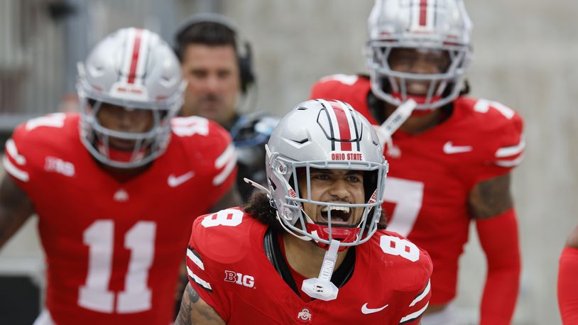 Ohio State defensive back Lathan Ransom, front, celebrates his touchdown against Akron during the second half of an NCAA college football game Saturday, Aug. 31, 2024, in Columbus, Ohio. (AP Photo/Jay LaPrete)