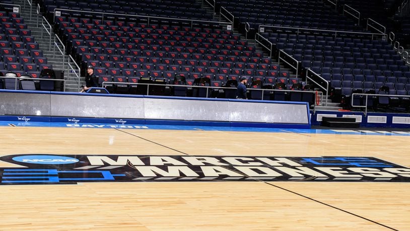 On St. Patrick's Day 2024, workers put the finishing touches on the basketball court installation for the First Four of the NCAA Division I Men’s Basketball Championship at UD Arena which will take place on March 19 & 20, 2024. TOM GILLIAM / CONTRIBUTING PHOTOGRAPHER