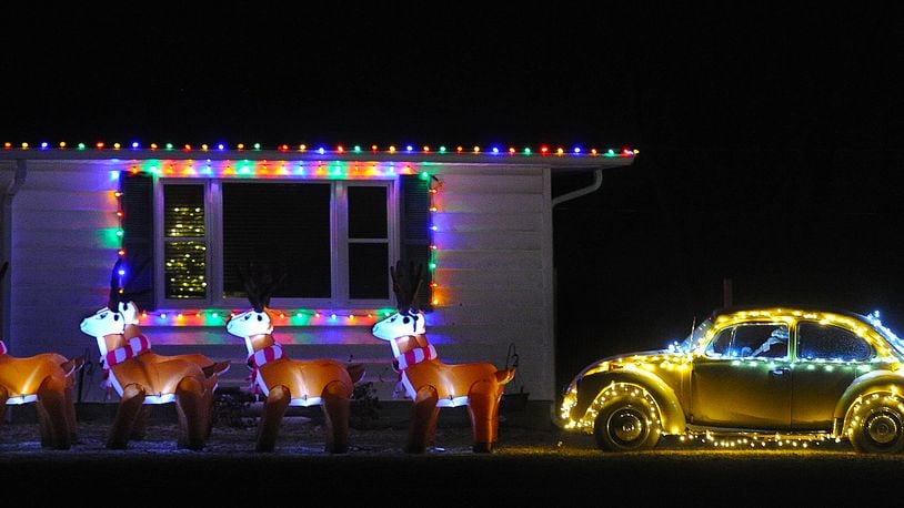 Tis the season. Eight blowup raindeer and Santa in his Volkswagen Beetle in a yard on Dayton Road near Enon. MARSHALL GORBY\STAFF