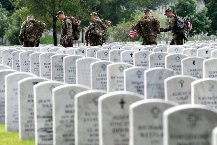 Soldiers place flags at Arlington National Cemetery for Memorial Day