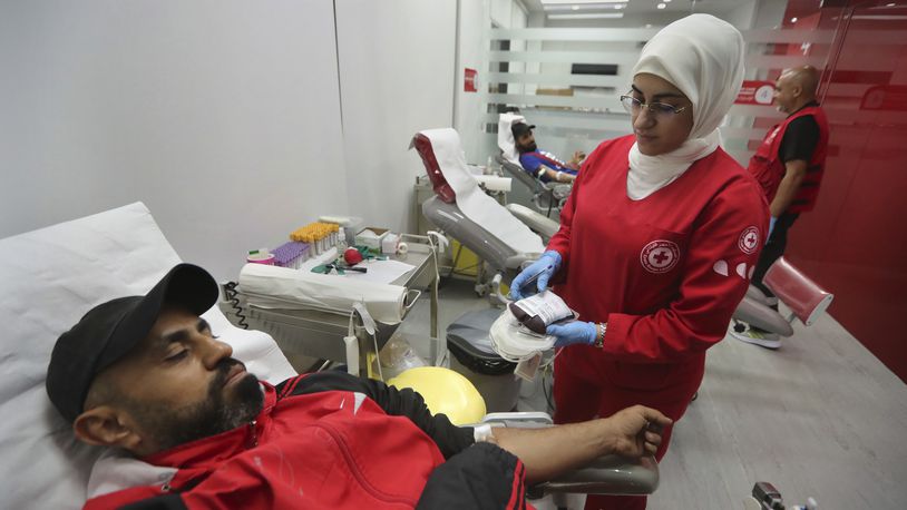 People donate blood for those who were injured by their exploded handheld pagers, at a Red Cross center, in the southern port city of Sidon, Lebanon, Tuesday, Sept. 17, 2024. (AP Photo/Mohammed Zaatari)