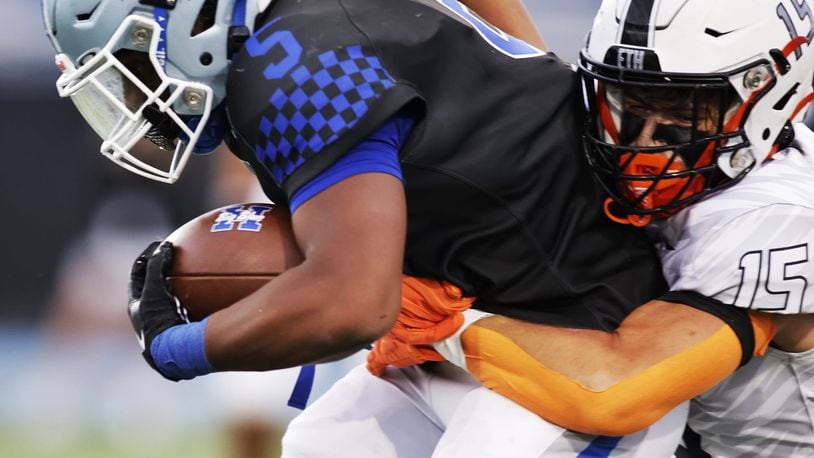 Hamilton's Gracen Goldsmith carries the ball defended by Lakota East's Carson Shroyer during their football game Friday, Sept. 6, 2024 at Virgil Schwarm Stadium in Hamilton. NICK GRAHAM/STAFF