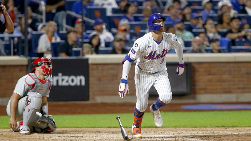 New York Mets' Brandon Nimmo, right, watches his solo home run in the sixth inning during a baseball game against the Philadelphia Phillies, Sunday, Sept. 22, 2024, in New York. (AP Photo/John Munson)