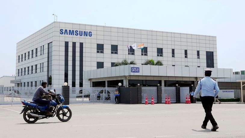 A motorcyclist rides past Samsung company plant in Sriperumbudur, on the outskirts of Chennai, India, Tuesday, Sept. 24, 2024. (AP Photo/Mahesh Kumar A.)