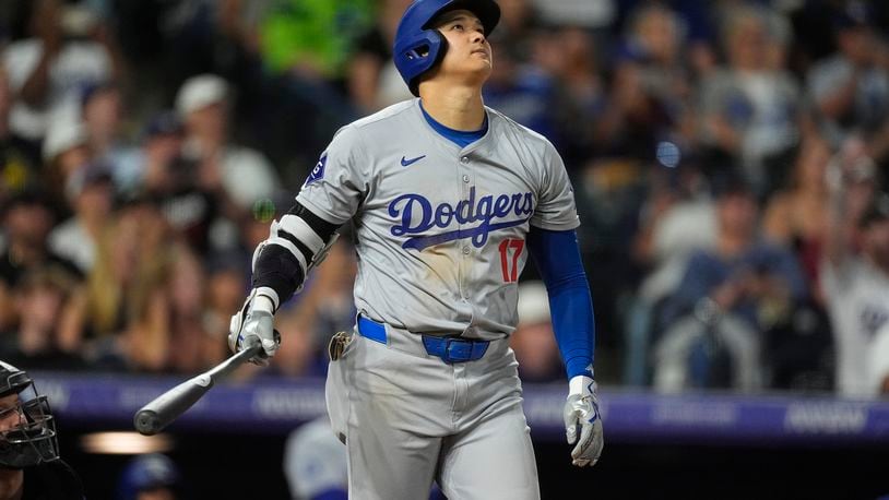 Los Angeles Dodgers' Shohei Ohtani watches the flight of his three-run home run off Colorado Rockies relief pitcher Anthony Molina in the sixth inning of a baseball game Friday, Sept. 27, 2024, in Denver. (AP Photo/David Zalubowski)