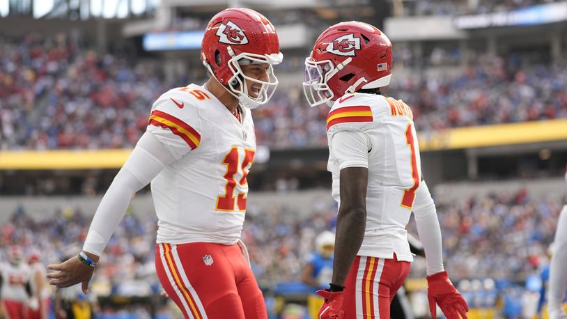 Kansas City Chiefs wide receiver Xavier Worthy, right, is celebrates after catching a 54-yard touchdown pass from teammate Patrick Mahomes, left, during the first half of an NFL football game against the Los Angeles Chargers Sunday, Sept. 29, 2024, in Inglewood, Calif. (AP Photo/Ashley Landis)