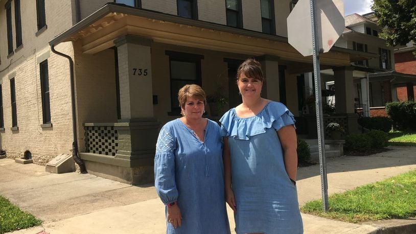 Missy Mick, director of project development, and Lori DiStaola, executive director of Neighborhood Housing Services of Hamilton, stand in front of a three-apartment building their non-profit organization operates on Campbell Avenue that helps people and families avoid, or transition from, homelessness. The apartments on Tuesday will be named after a longtime organization advocate, the late Louis R. Armstead. MIKE RUTLEDGE/STAFF