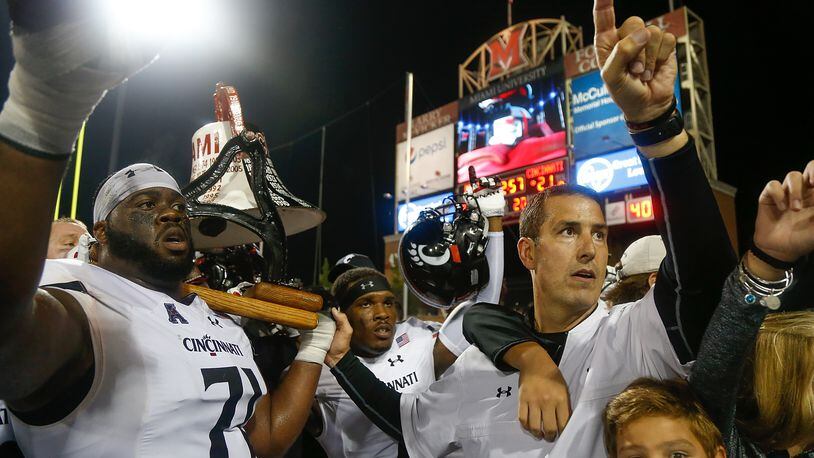 OXFORD, OH - SEPTEMBER 16: Head coach Luke Fickell and Korey Cunningham #71 of the Cincinnati Bearcats celebrate with the Victory Bell following their 21-17 win over the Miami Ohio Redhawks at Yager Stadium on September 16, 2017 in Oxford, Ohio. (Photo by Michael Reaves/Getty Images)