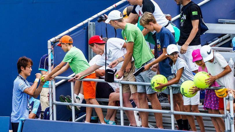 Fans will be unable to see some of the world’s best tennis players after the Western & Southern Open was moved from Mason to New York City for one year. Here, Yoshihito Nishioka signs autographs after beating Ales de Minaur last year. NICK GRAHAM/STAFF