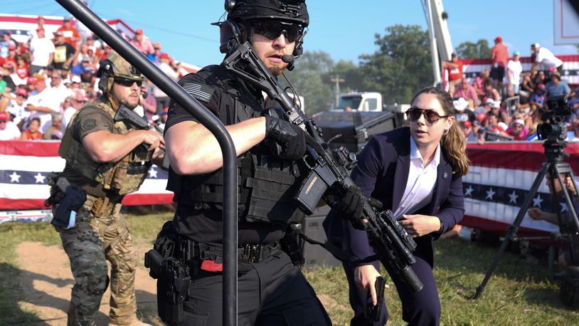 FILE - U.S. Secret Service agents respond as Republican presidential candidate former President Donald Trump is surrounded on stage by U.S. Secret Service agents at a campaign rally, July 13, 2024, in Butler, Pa. (AP Photo/Evan Vucci, File)