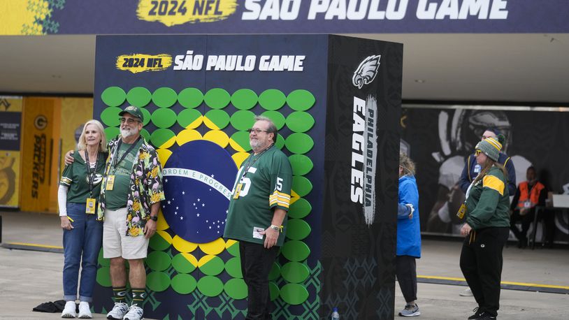 Fans pose for a picture before an NFL football game between the Philadelphia Eagles and the Green Bay Packers on Friday, Sept. 6, 2024, at the Neo Quimica Arena in Sao Paulo. (AP Photo/Andre Penner)