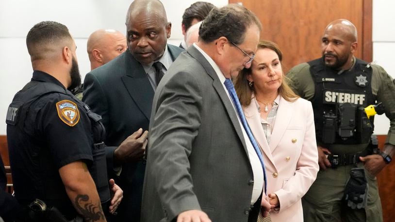 Former Houston police officer Gerald Goines is taken into custody and his defense attorneys Reagan Wynn, front center, and Nicole DeBorde Hochglaube, second right, react to the guilty verdict in his murder trial in the 482nd District Court at the Harris County Criminal courthouse Wednesday, Sept. 25, 2024, in Houston. A jury found Goines guilty of two counts of murder in the January 2019 deaths of Dennis Tuttle and his wife Rhogena Nicholas. (Melissa Phillip/Houston Chronicle via AP, Pool)