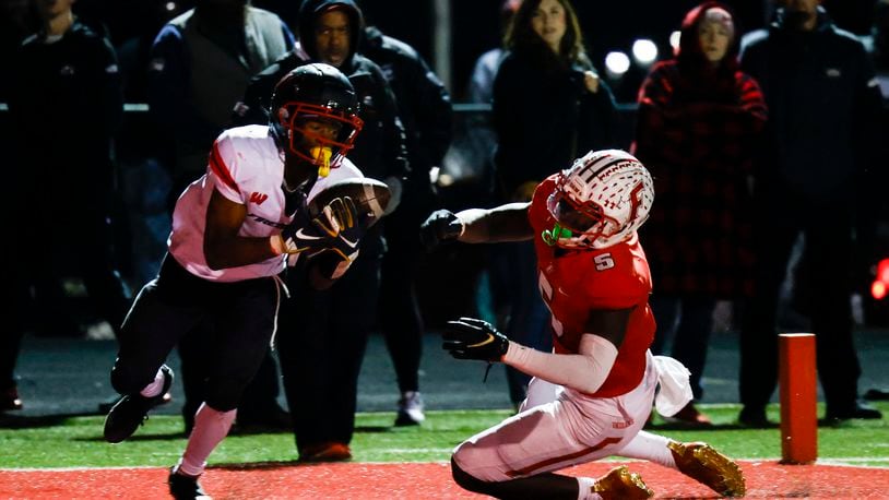 Lakota West's Kofi Adubofuor catches a touchdown pass  defended by Fairfield's Ray Coney. Lakota West defeated Fairfield 38-31 in double overtime in their football game Friday, Oct. 7, 2022 at Fairfield Stadium. NICK GRAHAM/STAFF