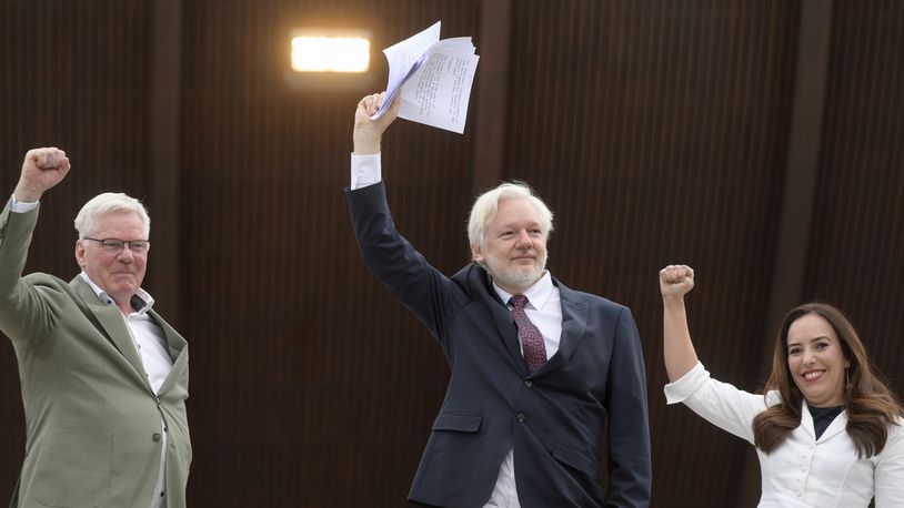 Wikileaks founder Julian Assange, center, his wife Stella Assange, right, and editor-in-chief of WikiLeaks Kristinn Hrafnsson, raise their fists as they arrive at the Council of Europe, in Strasbourg, eastern France, Tuesday, Oct. 1, 2024. (AP Photo/Pascal Bastien)