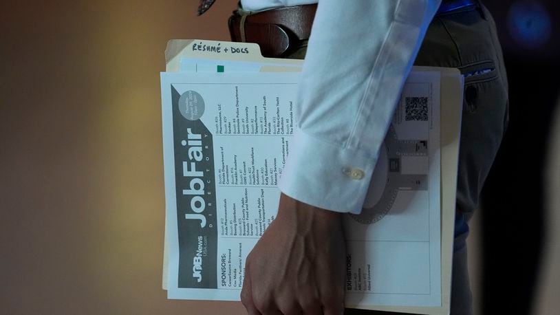 A person waits in a line for a prospective employer at a job fair, Thursday, Aug. 29, 2024, in Sunrise, Fla. (AP Photo/Lynne Sladky)