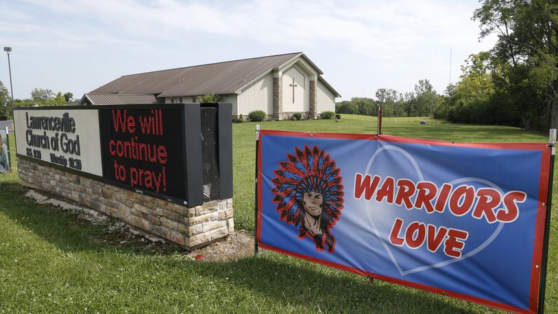 Signs in front of the Lawrenceville Church of God along Troy Road Thursday, August 24, 2024. BILL LACKEY/STAFF