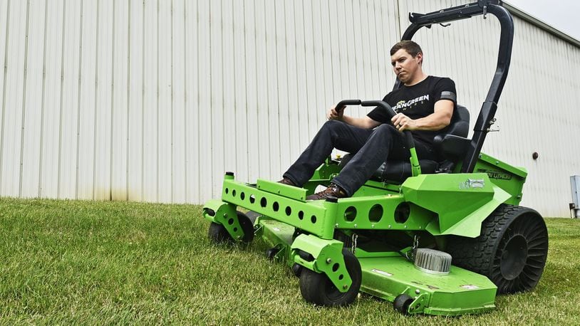 A Mean Green leader cuts grass with a demo unit outside the Mean Green Mowers facility in Ross Twp. in 2019. FILE