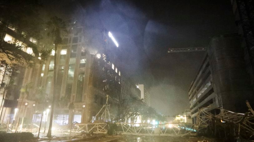 A crane is seen across 1st Avenue South near the Tampa Bay Times offices in St. Petersburg, Florida, Thursday, Oct. 10, 2024, as Hurricane Milton's strong winds tore through the area. (Chris Urso/Tampa Bay Times via AP)