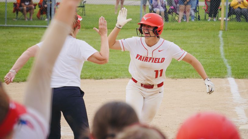 Fairfield's Karley Clark is congratulated by head coach Brenda Stieger as she rounds third base after hitting a home run against Ross on Monday night. Chris Vogt/CONTRIBUTED