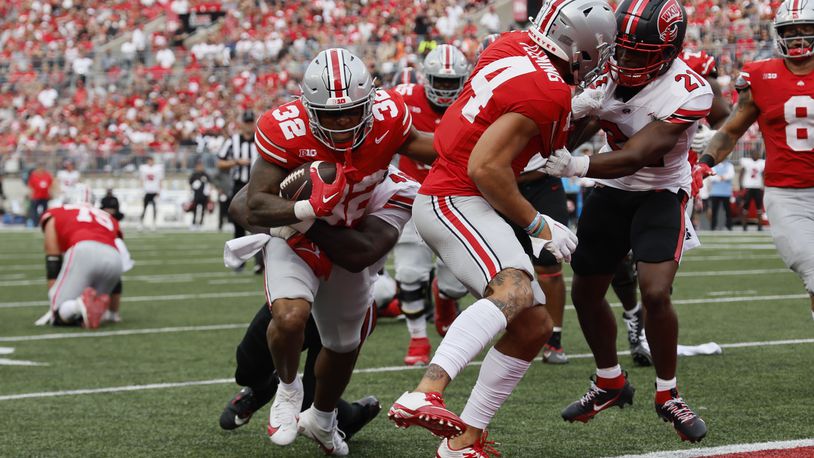 Ohio State running back TreVeyon Henderson, left, scores against Western Kentucky during the first half of an NCAA college football game Saturday, Sept. 16, 2023, in Columbus, Ohio. (AP Photo/Jay LaPrete)