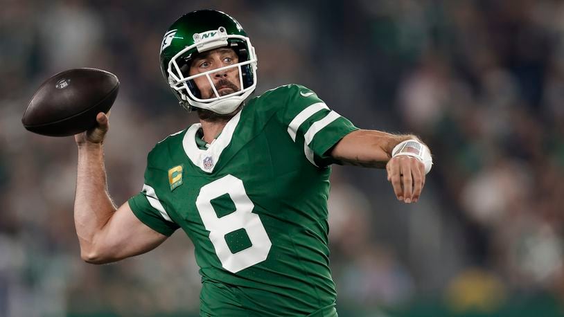 New York Jets quarterback Aaron Rodgers (8) passes against the New England Patriots during the first quarter of an NFL football game, Thursday, Sept. 19, 2024, in East Rutherford, N.J. (AP Photo/Adam Hunger)