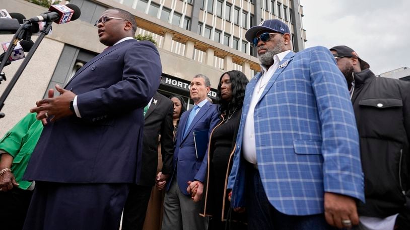 Rev. J. Lawrence Turner, left, leads a prayer vigil with the mother and stepfather of Tyre Nichols, RowVaughn Wells, second from right, and Rodney Wells, right, outside the federal courthouse during the trial of three former Memphis police officers accused of killing her son Wednesday, Sept. 25, 2024, in Memphis, Tenn. (AP Photo/George Walker IV)