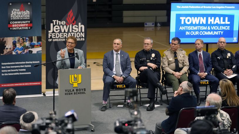 FILE - Los Angeles Mayor Karen Bass, at podium, addresses community members and other local, state law enforcement officials in a town hall on antisemitic violence at YULA Boys High School in Los Angeles Monday, Feb. 20, 2023. (AP Photo/Damian Dovarganes, File)