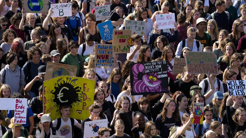 Students hold placards as they take part in a Global Climate Strike protest, part of the Fridays For Future movement, near the chancellery in Berlin, Germany, Friday, Sept. 20, 2024. (AP Photo/Markus Schreiber)