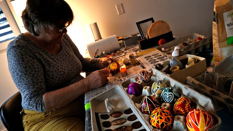 Vaka Pereyma decorates her Ukrainian Pysanky egg during a workshop Saturday, March 18, 2023 at Frank Lloyd Wright's Westcott House in Springfield. The workshop, taught by artist Christina Pereyma, teaches the ancient form of folk art that originated in Ukraine in pre-Christian times. It involves melting wax and applying it an egg in intricate patterns then dying the eggs in stages to get the desired design. All the proceeds from the registration fee for the workshop will go toward the Ukraine Heritage Response Fund.  BILL LACKEY/STAFF