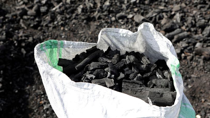 FILE - A sack of charcoal is filled in Gulu, Uganda on May 27, 2023. (AP Photo/Hajarah Nalwadda, File)