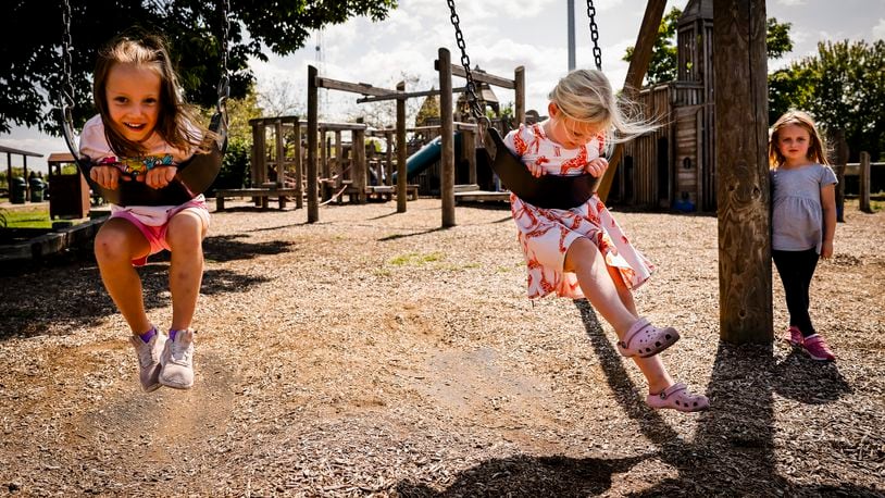 Ava Johnson, 5, left, and Natalie Back, 4, swing while Chloe Anderson, 4, watches at Fort Liberty Playland Wednesday, Aug. 21, 2024 on Van Gorden Road in Liberty Township. NICK GRAHAM/STAFF