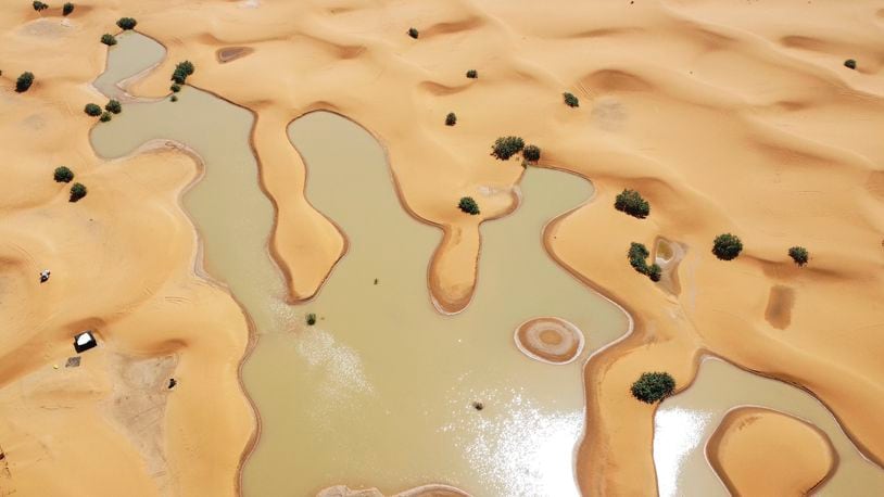 A view of lakes caused by heavy rainfall between sand dunes in the desert town of Merzouga, near Rachidia, southeastern Morocco, Wednesday, Oct. 2, 2024. (AP Photo)