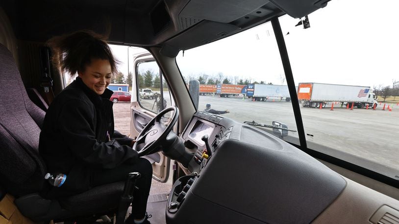 Nina Haynes, 17, a senior student from Middletown High School, climbs in a truck on Tuesday to get a glimpse of many job and training opportunities available during an Experiential Learning Day at the CDL driver training pad at Butler Tech. NICK GRAHAM/STAFF